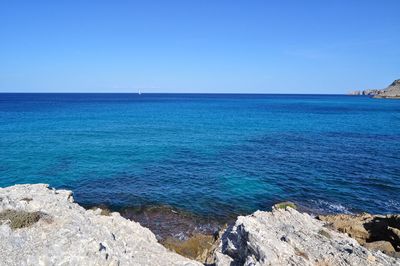 Scenic view of sea against clear blue sky