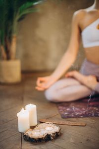 Midsection of woman sitting on table