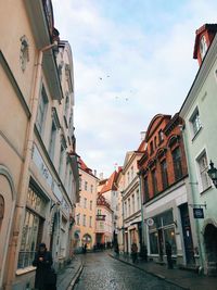 Street amidst buildings in city against sky
