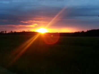 Scenic view of field against sky during sunset