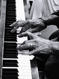 Close-up of hands playing piano