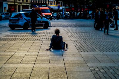 People sitting on floor in city