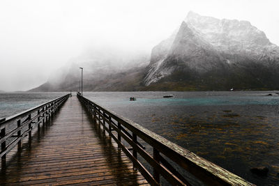 Wooden bridge pier at the coast in moskenesoya on a cold day in the winter in lofoten norway