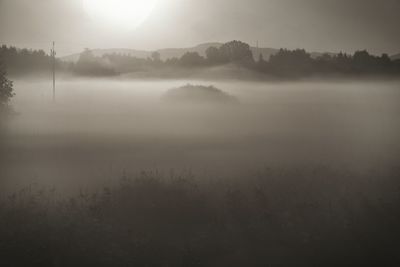 Scenic view of calm lake against cloudy sky