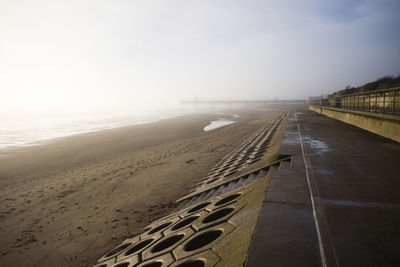 The shoreline and sea defences at skegness on a misty morning at low tide