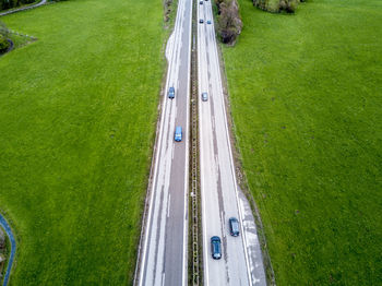 High angle view of car moving on road amidst field