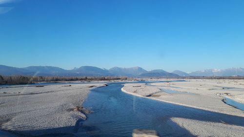 Scenic view of desert against clear blue sky