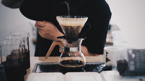 Man pouring coffee in cup