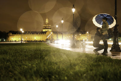 Man and woman romancing on road at night