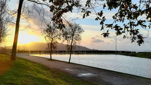 Scenic view of river against sky during sunset