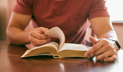 Midsection of woman reading book