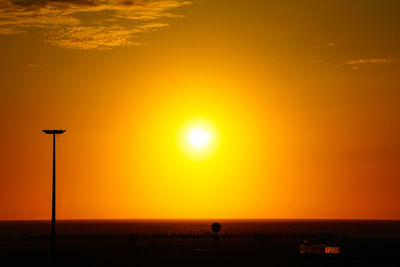 Scenic view of sea against orange sky