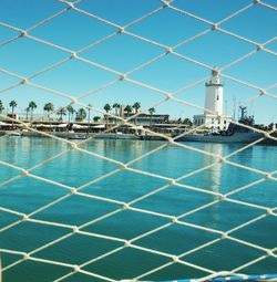 Swimming pool by sea against sky