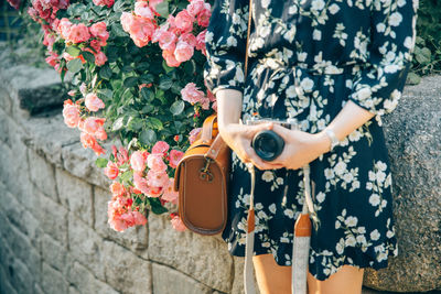 Midsection of woman holding flower pot