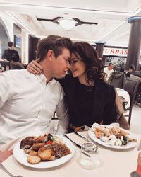 Couple cuddling in restaurant