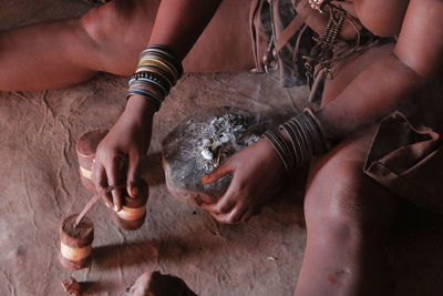 Midsection of woman with wooden equipment