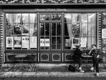 People sitting in front of building