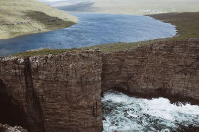 Scenic view of sea by mountain