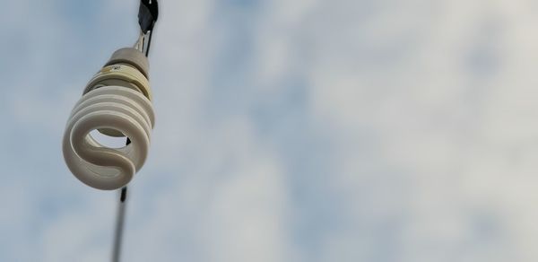 Low angle view of electric light against building