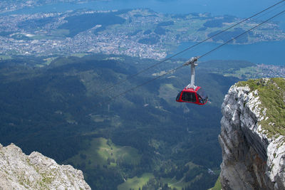 A gondola lift or aerial tramway lifting tourists to the top of a mountain. switzerland
