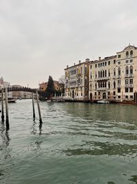 Scenic view of sea by buildings against sky