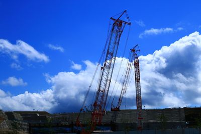 Low angle view of crane against sky