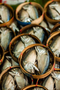 Full frame shot of fishes in baskets at market for sale