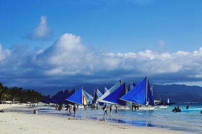 Scenic view of beach against cloudy sky