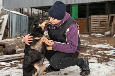 Girl volunteer in the nursery for dogs. shelter for stray dogs.