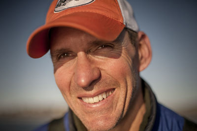 Close-up of smiling man against clear sky