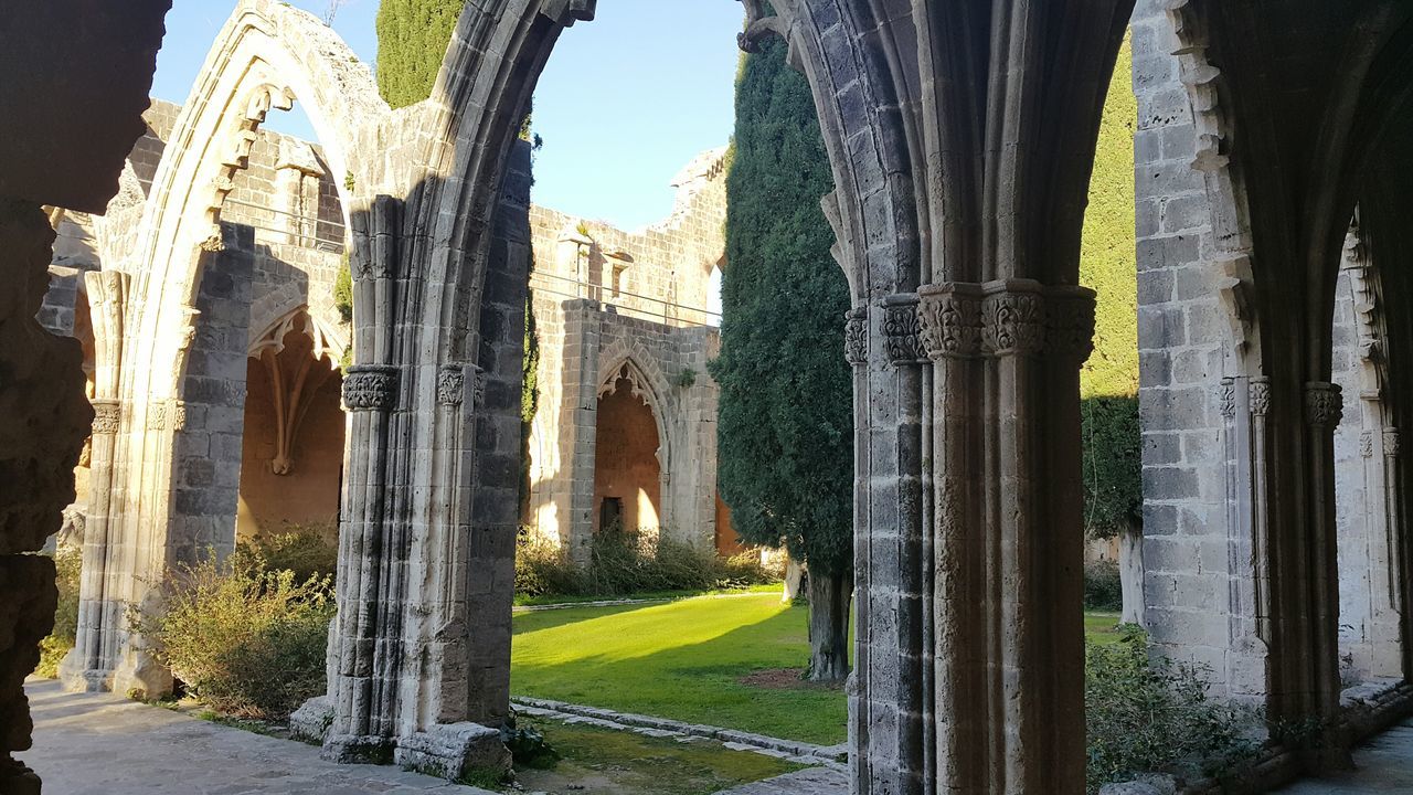 architecture, built structure, building exterior, place of worship, history, religion, spirituality, arch, famous place, travel destinations, church, tree, architectural column, cathedral, tourism, travel, sky, day