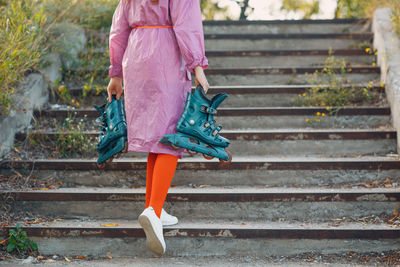 Low section of woman walking on staircase