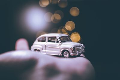 Cropped hand of person holding toy car