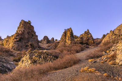 Panoramic view of rocky mountains against clear sky