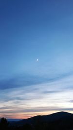 Scenic view of silhouette mountains against sky at night