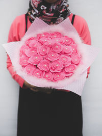 Close-up of woman with pink hair standing on hand