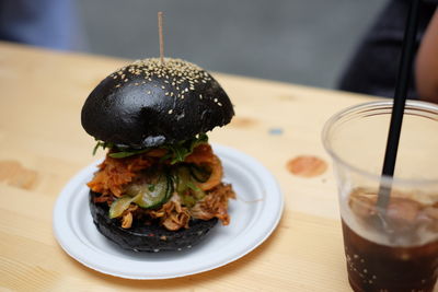 Burger served in plate on table at restaurant