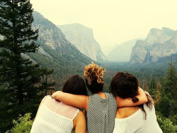 Rear view of female friends against mountains