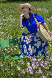 Portrait of smiling woman standing on field