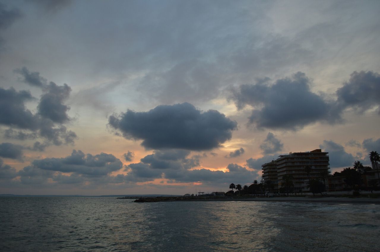 sea, architecture, water, building exterior, sunset, sky, built structure, waterfront, cloud - sky, horizon over water, silhouette, scenics, cloudy, cloud, beauty in nature, tranquility, tranquil scene, nature, outdoors, building