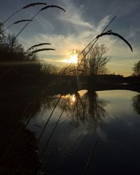 Scenic view of lake at sunset