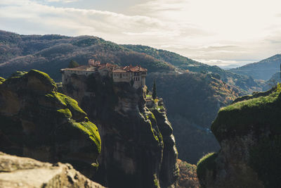 Aerial view of building on rock mountains against sky