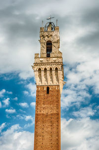 Low angle view of clock tower against sky