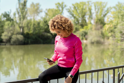 Athlete woman using her smartphone
