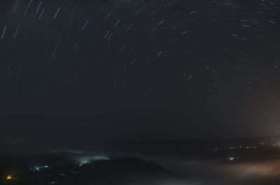 Aerial view of illuminated city against sky at night