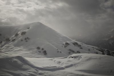 Scenic view of snow covered mountains against sky