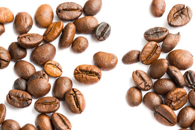 Close-up of coffee beans against white background