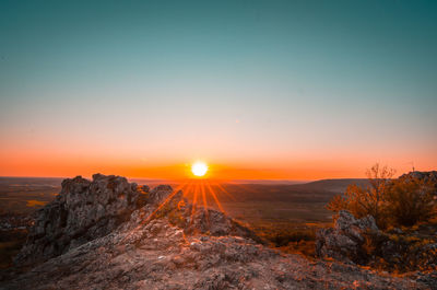 Scenic view of landscape against sky during sunset