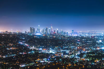 High angle view of city lit up at night