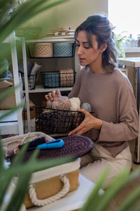 Portrait of young woman holding food at home